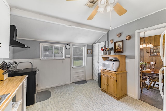 kitchen with ceiling fan, black / electric stove, wall chimney exhaust hood, and vaulted ceiling