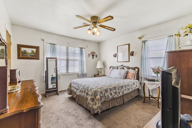 bedroom with light carpet and ceiling fan