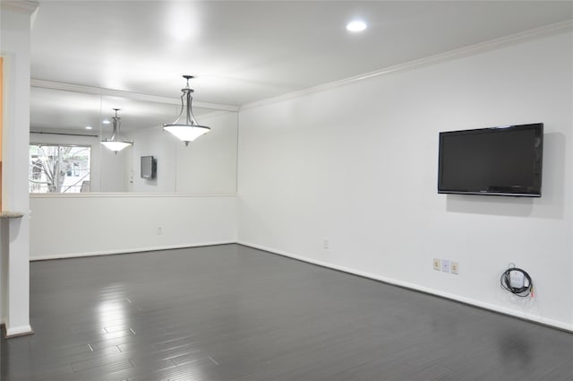 unfurnished living room featuring crown molding and dark wood-type flooring