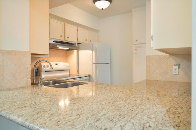 kitchen with decorative backsplash, white appliances, sink, and white cabinets