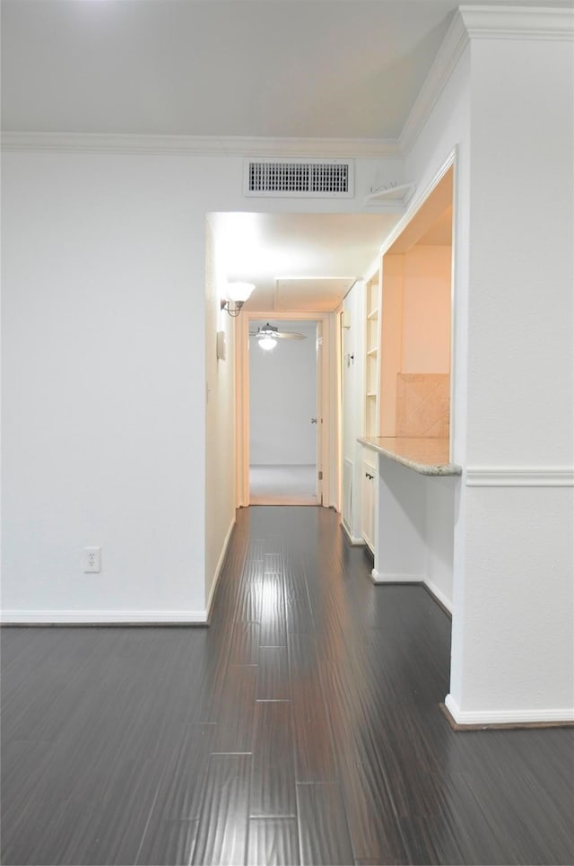 hall featuring dark hardwood / wood-style floors and crown molding