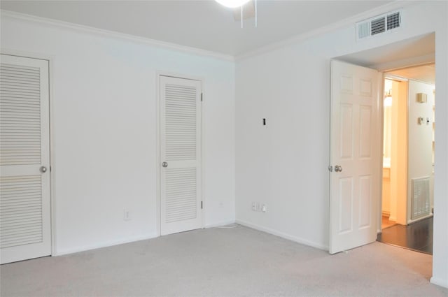 unfurnished bedroom with ornamental molding and light carpet