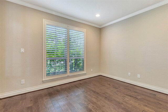 spare room with hardwood / wood-style floors and crown molding