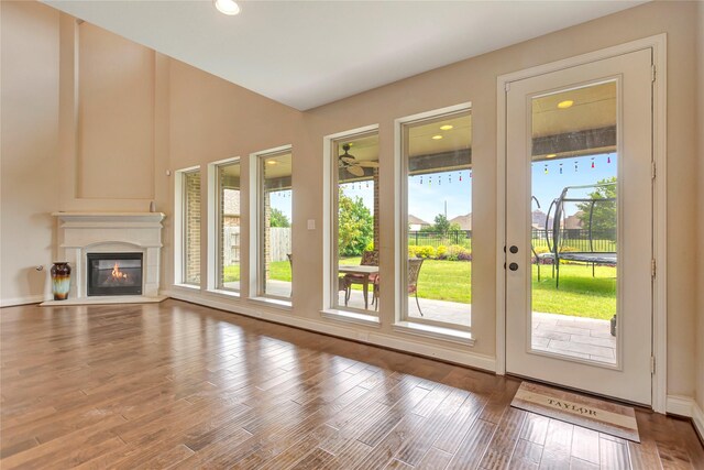 unfurnished living room with hardwood / wood-style floors and a healthy amount of sunlight