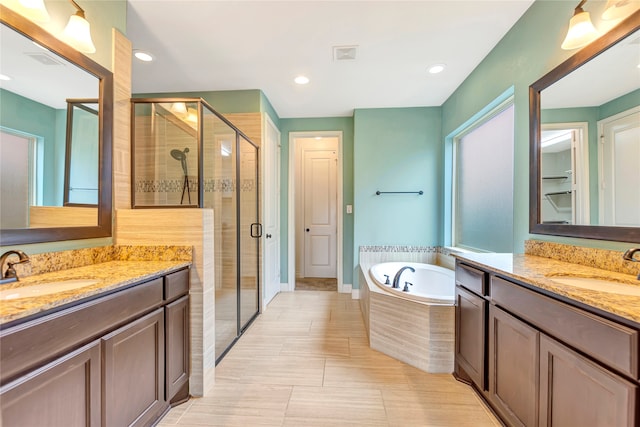 bathroom with vanity and separate shower and tub