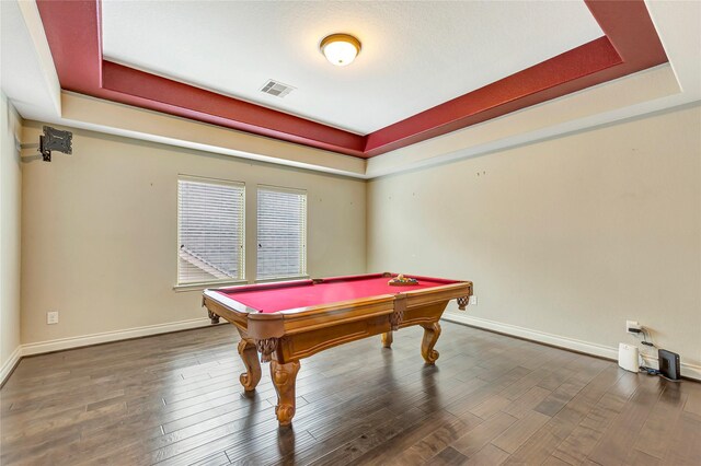 recreation room featuring pool table, a tray ceiling, and dark hardwood / wood-style floors