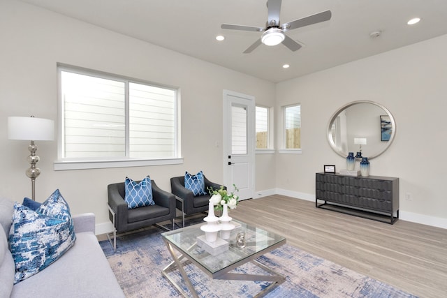 living room with ceiling fan and hardwood / wood-style flooring