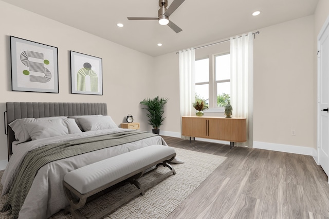 bedroom with ceiling fan and light wood-type flooring