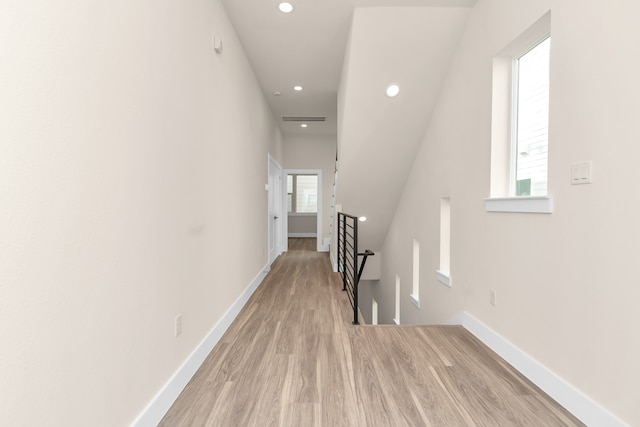 corridor featuring light hardwood / wood-style flooring and a wealth of natural light