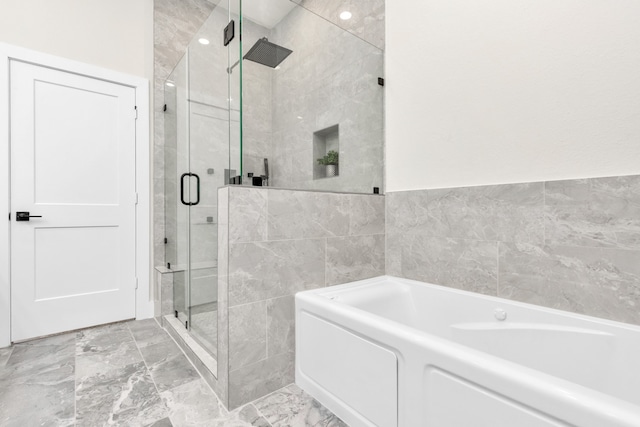 bathroom with plus walk in shower and tile walls