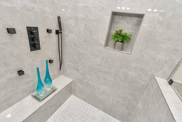 bathroom with a tile shower