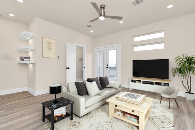 living room with ceiling fan and light hardwood / wood-style flooring