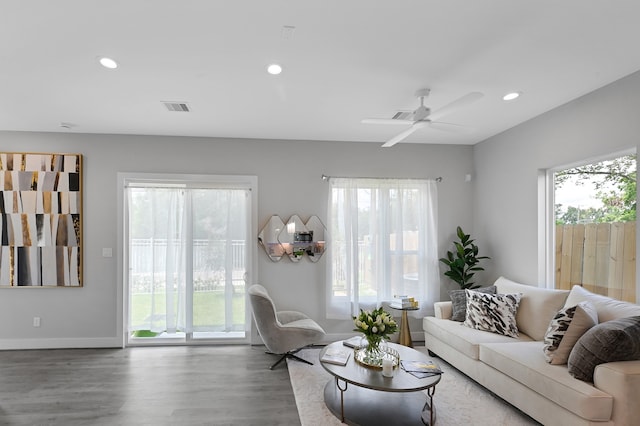 living room featuring ceiling fan, hardwood / wood-style flooring, and a wealth of natural light