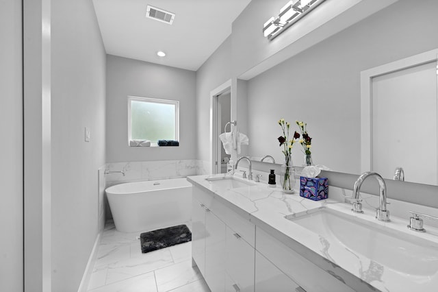 bathroom with vanity and a washtub