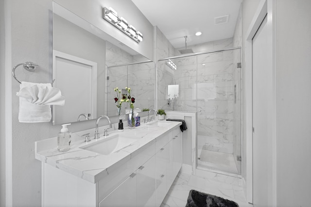 bathroom with vanity and a shower with door