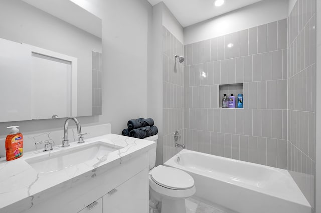 full bathroom featuring tiled shower / bath combo, vanity, and toilet