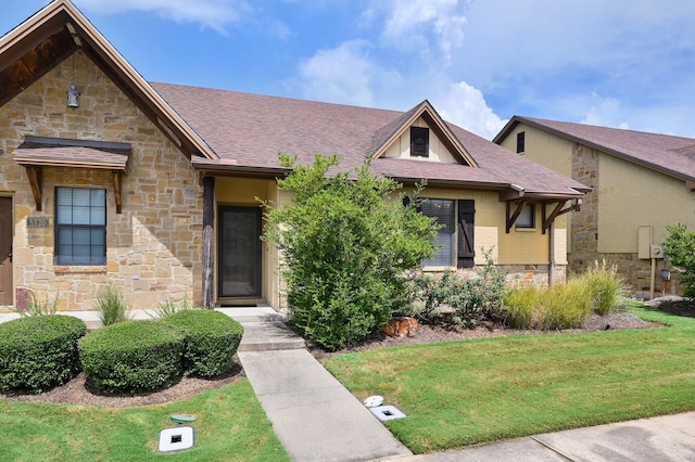 english style home featuring a front lawn