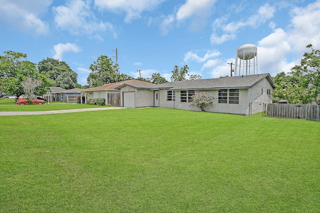 ranch-style home with a garage and a front lawn