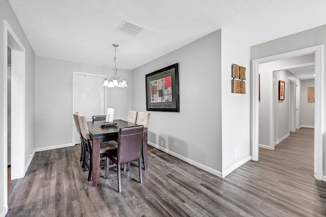 dining room featuring a notable chandelier and dark hardwood / wood-style floors