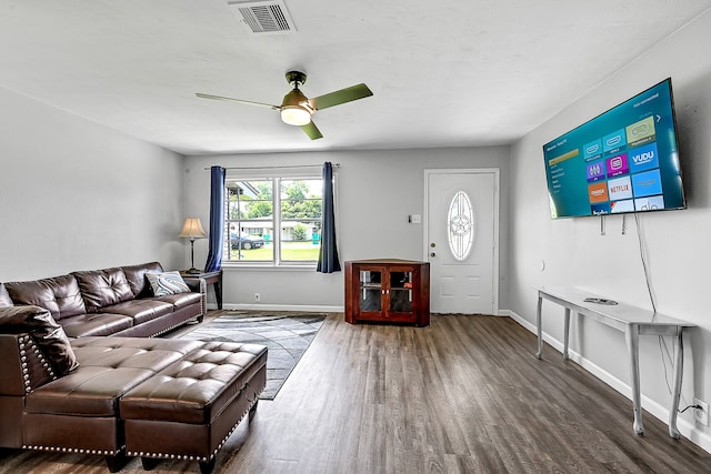 living room featuring ceiling fan and dark hardwood / wood-style floors