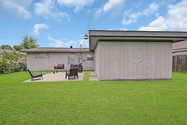 back of house featuring a lawn and a patio