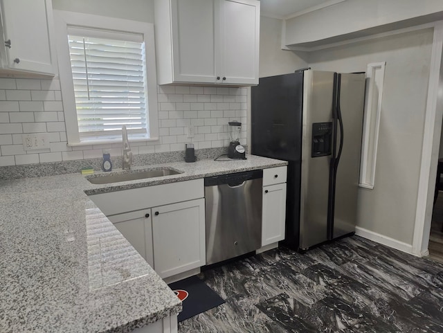 kitchen with decorative backsplash, white cabinets, light stone countertops, stainless steel appliances, and sink