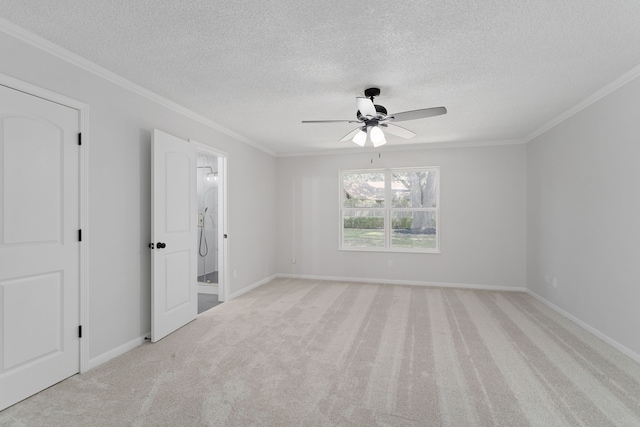 carpeted empty room with a textured ceiling, crown molding, and ceiling fan