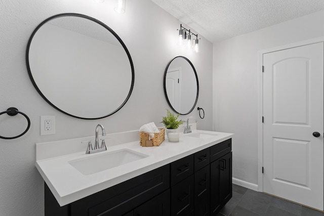 bathroom featuring tile patterned floors, a textured ceiling, and vanity