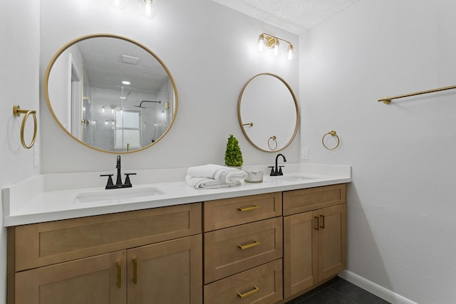 bathroom featuring vanity, a textured ceiling, tile patterned flooring, and an enclosed shower