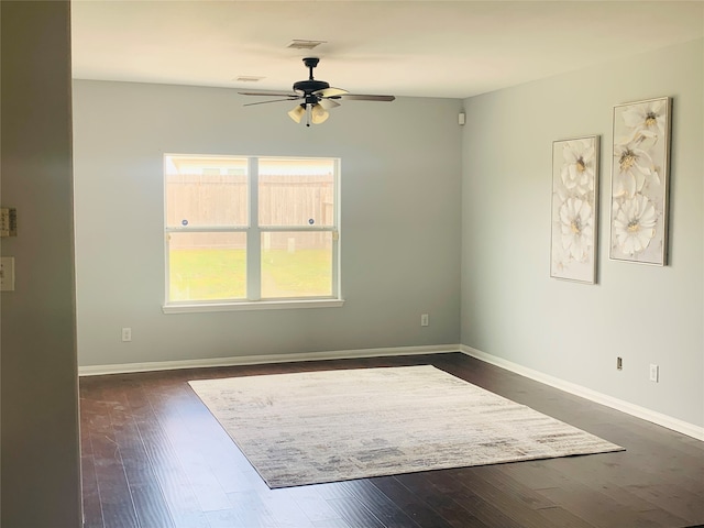 unfurnished room with dark wood-type flooring and ceiling fan