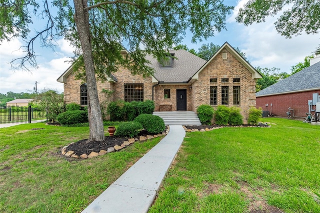 view of front of home with cooling unit and a front yard