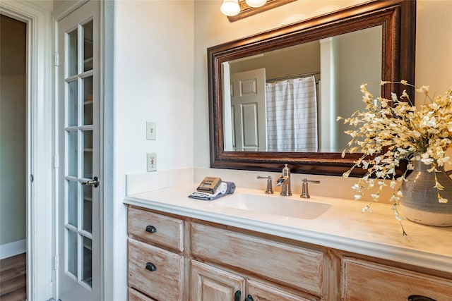 bathroom with hardwood / wood-style floors and vanity