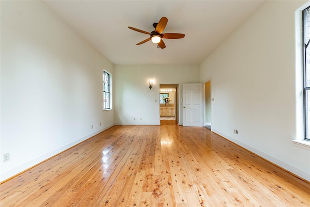 unfurnished bedroom with multiple windows, light wood-type flooring, and ceiling fan