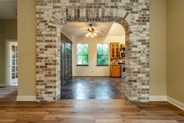 entrance foyer featuring ceiling fan and dark wood-type flooring