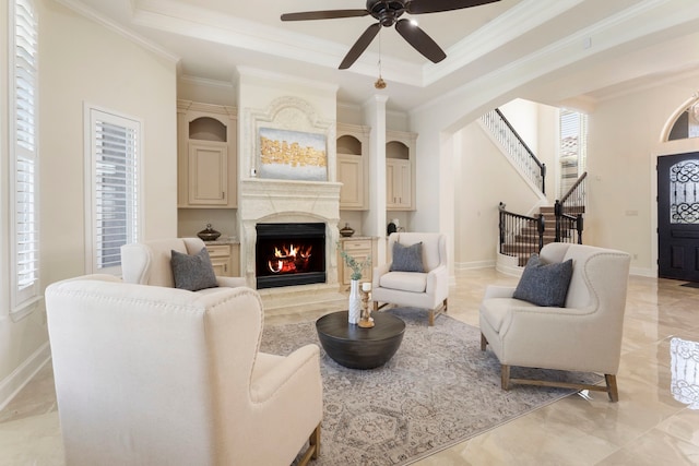 living room featuring crown molding, a tray ceiling, plenty of natural light, and ceiling fan