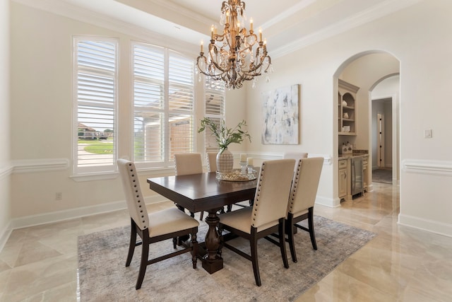 dining room with wine cooler, ornamental molding, and a chandelier