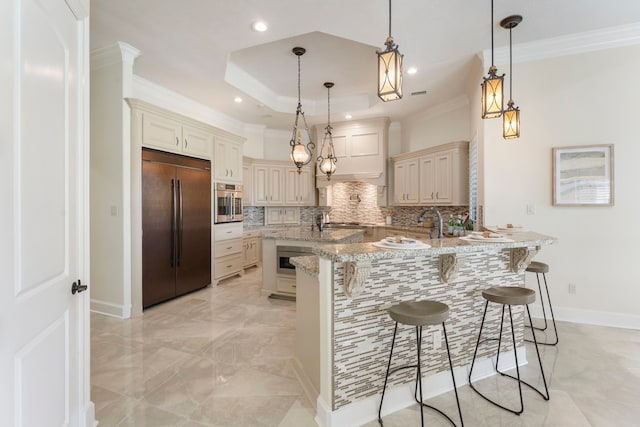 kitchen featuring a kitchen breakfast bar, appliances with stainless steel finishes, and pendant lighting