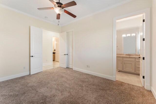 unfurnished bedroom with ensuite bath, light carpet, ornamental molding, and ceiling fan