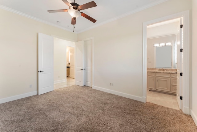 unfurnished bedroom featuring baseboards, ornamental molding, and light colored carpet