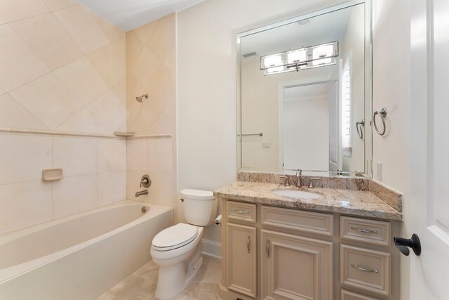 full bathroom featuring vanity, toilet, and tiled shower / bath