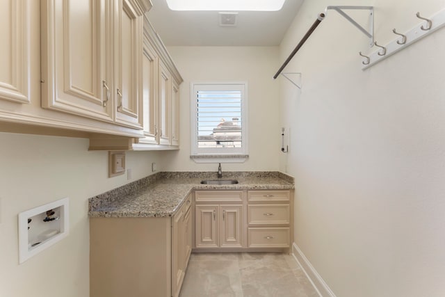 laundry area featuring washer hookup, cabinet space, visible vents, a sink, and baseboards