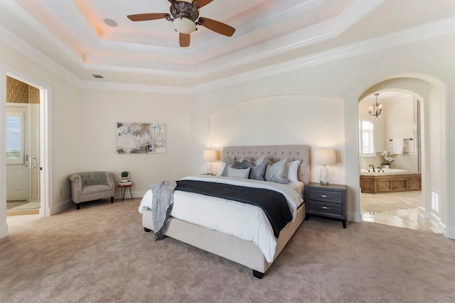 bedroom with light carpet, multiple windows, ensuite bath, and ceiling fan