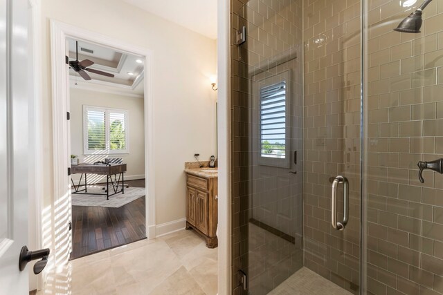 bathroom with a tray ceiling, an enclosed shower, hardwood / wood-style floors, vanity, and crown molding