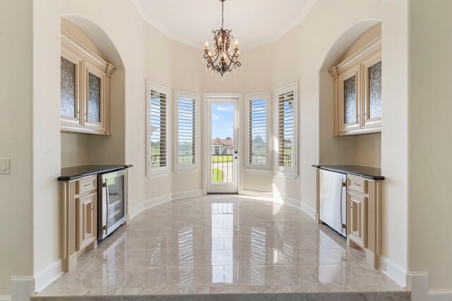 interior space featuring a notable chandelier, wine cooler, and crown molding