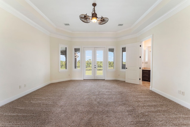 empty room with light carpet, visible vents, baseboards, french doors, and ornamental molding