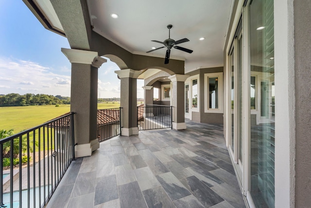 view of patio / terrace with ceiling fan and a balcony