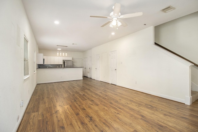 unfurnished living room with dark wood-style flooring, a ceiling fan, visible vents, and recessed lighting