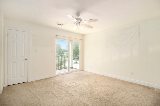 carpeted spare room with ceiling fan