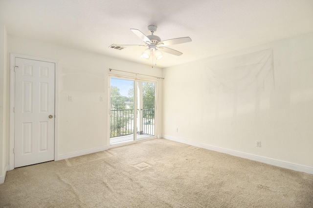 empty room featuring baseboards, ceiling fan, carpet floors, and visible vents