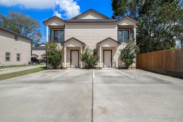 view of front of house featuring a balcony and a garage